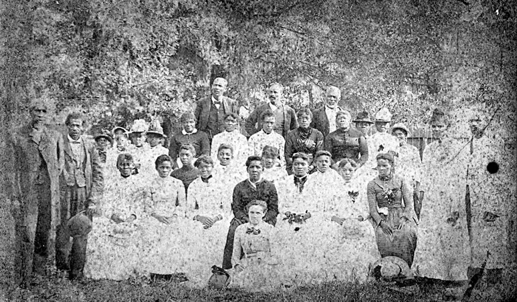 A group photograph of 31 people at a Juneteenth Celebration in Emancipation Park in Houston's Fourth Ward.